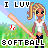 Pixel art icon of a blonde girl with blue eyes holding a pink bat, standing on green grass under a blue sky with text reading "I LUV SOFTBALL".