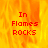 A static image with a fiery orange-yellow background and red pixelated text reading "In Flames ROCKS" in three lines.