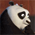Pixelated close-up of a panda's head with black and white fur, dark eyes, and a brown background.