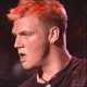 16 showing a person with red-tinted hair in a dark shirt against a dark background, with visible mouth and head position changes