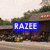 A static image shows a building with greenery and a sign reading 'RAZEE' in blue, then 'for' in red, and finally 'LIFE!!!' in green.