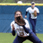 Pixelated image of a softball player in mid-pitch with another player and field background, paired with text about loving softball.