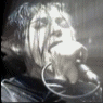 A monochrome animated sequence shows a person singing into a microphone with dynamic lighting and motion blur effects.