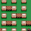 Pixel art grid of brown brick structures on green background with white rectangular elements and black gaps between some bricks.