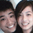 Two pixelated faces in close-up, both smiling with visible teeth, dark hair, and light skin tones against a blurred background.