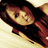 Pixelated image of a person with dark hair and a red garment against a light background, rendered in a low-resolution style.