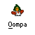 Pixelated character with green hair, orange face, red cape, white shirt, and black pants standing above stylized text.