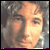 Pixelated static image of a person's face with warm lighting and blurred background, likely from an old AOL Instant Messenger buddy icon.