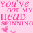 Static pink pixelated image with text 'YOU'VE GOT MY HEAD SPINNING' and two heart symbols on a light pink background.