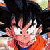 Pixelated static image of a character with spiky black hair, orange top, and raised hand in a gesture.
