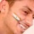 Pixelated close-up of a person's face showing partial features including eyes, nose, and mouth with visible teeth.