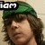 A pixelated image split into two sections: left shows a person with brown hair and green cap, right displays a silver star-shaped icon on black background.