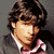 A pixelated image of a person with dark hair in three distinct poses showing different clothing and background variations.