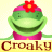 Pixelated green cartoon character with red flower on head, pink outfit, and yellow text "Croaky" below against light background.
