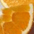 A pixelated orange and yellow abstract shape with a rounded central form and irregular edges against a light background.
