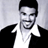 Static 48x48 pixel icon of a man with short dark hair, light skin tone, and facial stubble wearing a white collared shirt under a black jacket against a gray background.