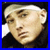 A pixelated contact sheet of two frames showing a person with a white headband and dark clothing on the left, next to bold black text reading "EMINEM IS Sexy!" on the right.
