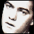 Pixelated face with neutral expression, dark eyebrows, and closed mouth on white background with black border.
