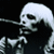 A pixelated skeleton with long hair holding a microphone against a black background, next to green text reading "Original Icons .com" on a dark green backdrop.