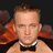 A pixelated image shows a person with light hair and glasses wearing a black bow tie against a dark background, next to red text reading "Chris Lights my Fire".