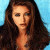 A pixelated image of a woman with long brown hair against a light blue background, next to green text reading 'Original Icons .com' on dark green.