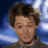 A 48x48 pixel buddy icon split into two vertical sections: a person with brown hair on the left and green text reading "Original Icons .com" on a dark green background on the right.