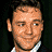 A 4-frame contact sheet of a pixelated animated icon featuring Russell Crowe with varying facial expressions and poses, alongside the text "Coolbuddy.com" on a black background.