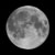 A static grayscale image of a full moon with visible craters and maria against a black background.