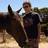 A pixelated image shows a person standing outdoors with a horse, overlaid with red text reading "i love my horses and boyfriend."