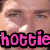 A pixelated face with a smiling expression, partially overlaid by pink text reading 'hottie' with black outline.
