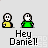 Pixel art animation of two figures with white heads and green bodies, one holding a yellow object, saying "Hey Daniel!" with red splatter effects appearing sequentially.