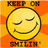 A static pixel art image of a yellow smiley face with closed eyes and a wide grin, set against an orange background with radiating lines. Text elements appear above and below the face.