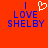 Red background with blue text reading "I LOVE SHELB" and a white pixelated heart symbol above the text.