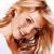 Pixelated static image of a person's face with light brown hair and neutral expression on white background.
