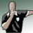 Pixelated figure in black uniform with white accents performing a kicking motion against gradient background.
