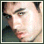 Pixelated close-up of a person's face with light skin tone, dark eyebrows, and visible eye details, framed by a thin dark border.