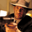 Static 48x48 pixel icon showing a stylized figure in warm tones with a hat and dark clothing, partially cropped on the right side.