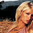 Pixelated static image of a person with long blonde hair in profile view against dark background, rendered at low resolution with visible dithering and color blending.