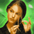 Pixelated image of a person with light brown hair wearing a dark top, holding a thin object near their face against a green background.