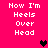 Pixelated text 'Now I'm Heels Over Head' on bright pink background with black and dark red heart symbols.