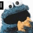 Animated blue muppet-like character with large eyes and black mouth, holding a cookie in one frame while text reads 'COOKIES!' at bottom.