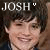 Pixelated image of a person with dark hair and light skin, wearing a dark top, under text reading JOSH with a small heart symbol.