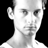 Static grayscale pixelated image of a person's head and shoulders against black background with white clothing visible at bottom.