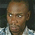 A 50x50 pixel buddy icon split into two frames showing a person in a checkered shirt on the left and green text reading "Original Icons .com" on the right against a dark background.