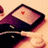 A 48x48 pixel animated buddy icon showing a dark purple and black device with a light beige screen displaying a small red square that changes to cyan across two frames.