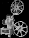 Black-and-white image of a vintage film projector with two reels, one above and one below the main body, on a dark background.