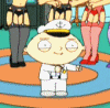 Animated cartoon character in white sailor uniform with anchor emblem on cap, standing on orange circular platform surrounded by background figures.