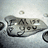 Pixelated grayscale image with partial text 'IF YOU' visible on a curved surface, alongside black pixelated text reading 'so much' on the right.