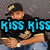 Pixelated image of a person wearing black cap with yellow emblem, black shirt, and blue jeans holding an object in both hands.