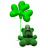 Green four-leaf clover balloon held by a green frog-like figure against white background.
